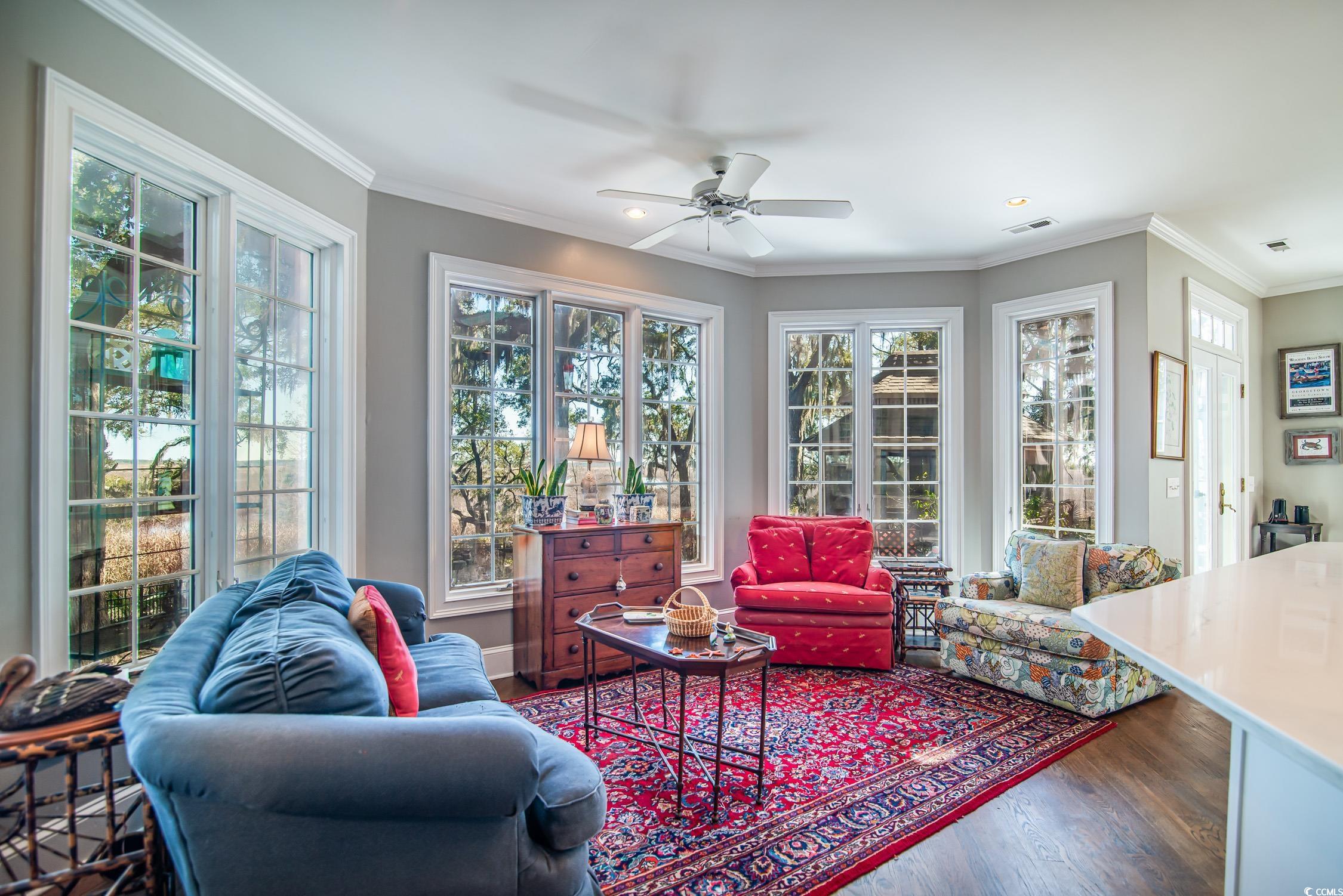 762 Wraggs Ferry Road Georgetown, SC 29440 - Photo 15 of 33 Living area with a wealth of natural light, visible vents, crown molding, and wood finished floors