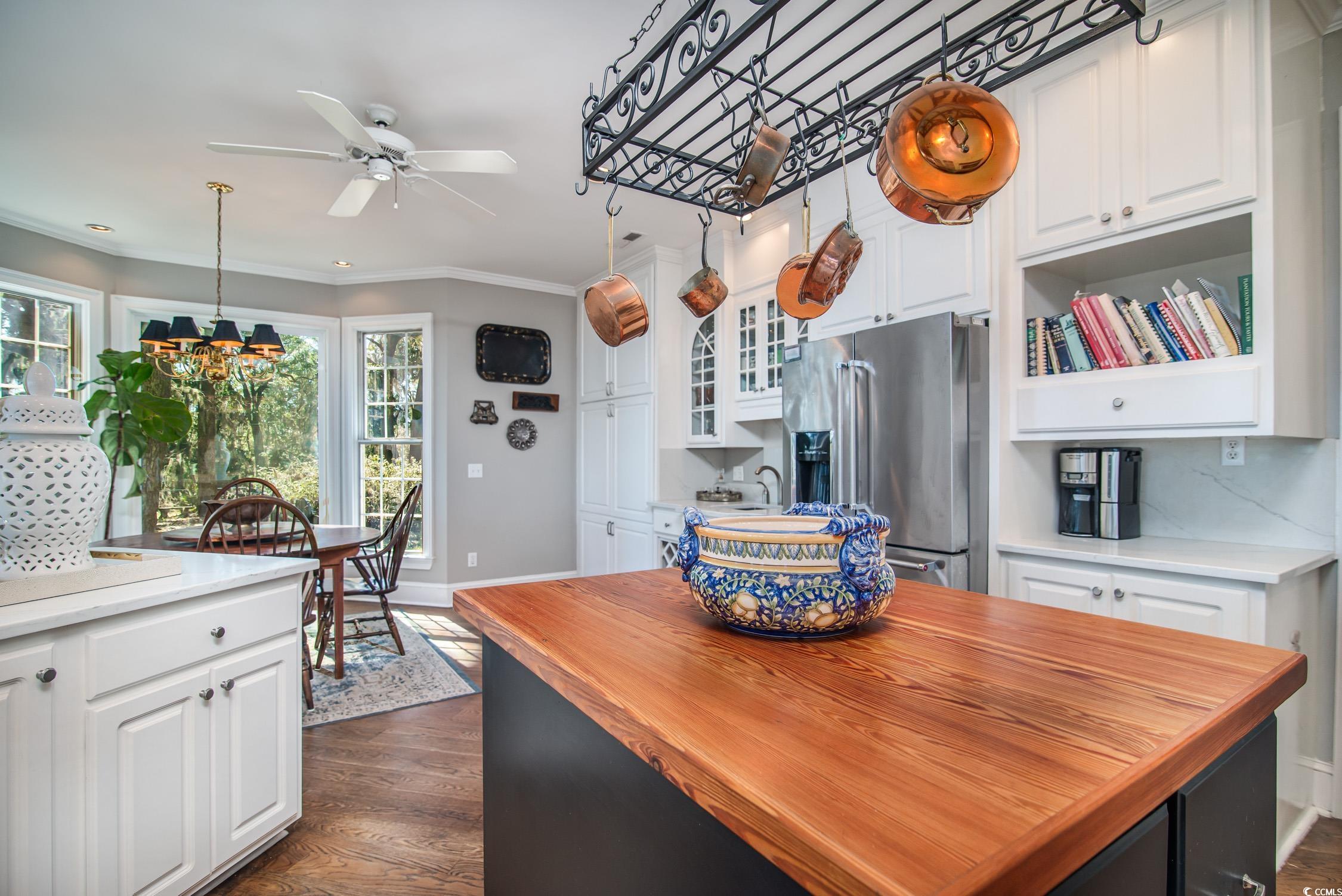 762 Wraggs Ferry Road Georgetown, SC 29440 - Photo 20 of 33 Kitchen featuring dark wood-style flooring, ornamental molding, white cabinets, wood counters, and stainless steel fridge with ice dispenser