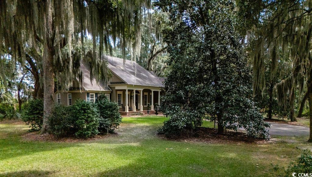 762 Wraggs Ferry Road Georgetown, SC 29440 - Photo 4 of 33 Rear view of house with covered porch and a yard