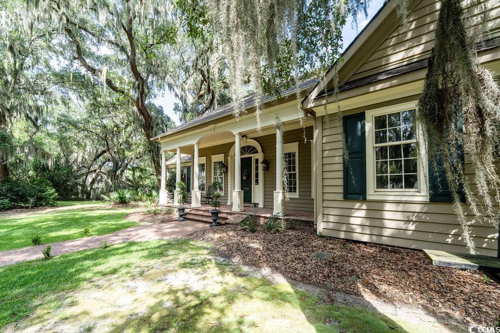 762 Wraggs Ferry Road Georgetown, SC 29440 - Photo 5 of 33 View of side of home featuring a porch and a yard