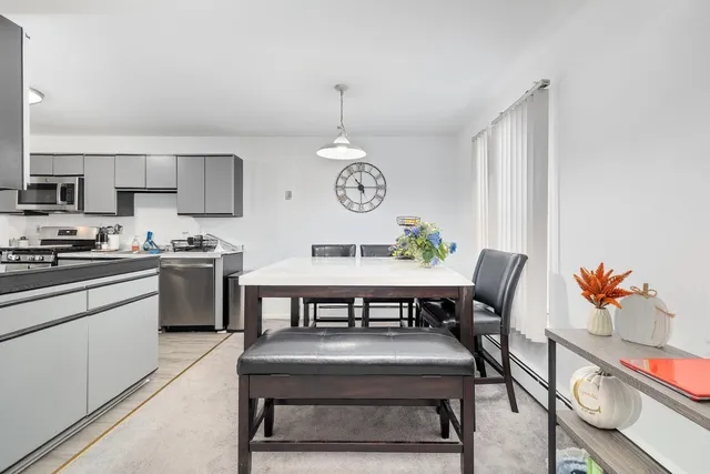 a kitchen with a dining table chairs and a stove