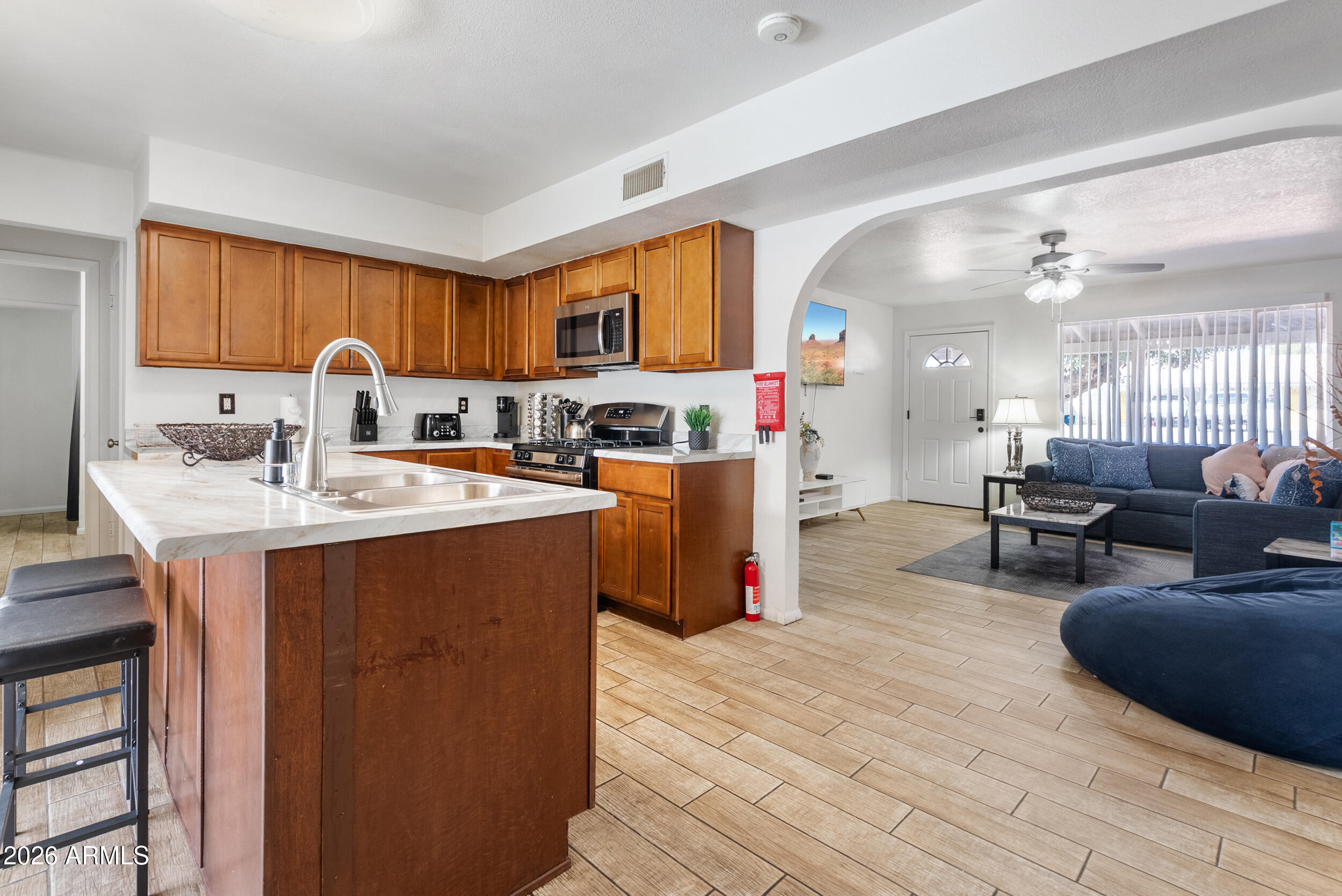 3631 West Colter Street Phoenix, AZ 85019 - Photo 10 of 45 a kitchen with a sink appliances and cabinets