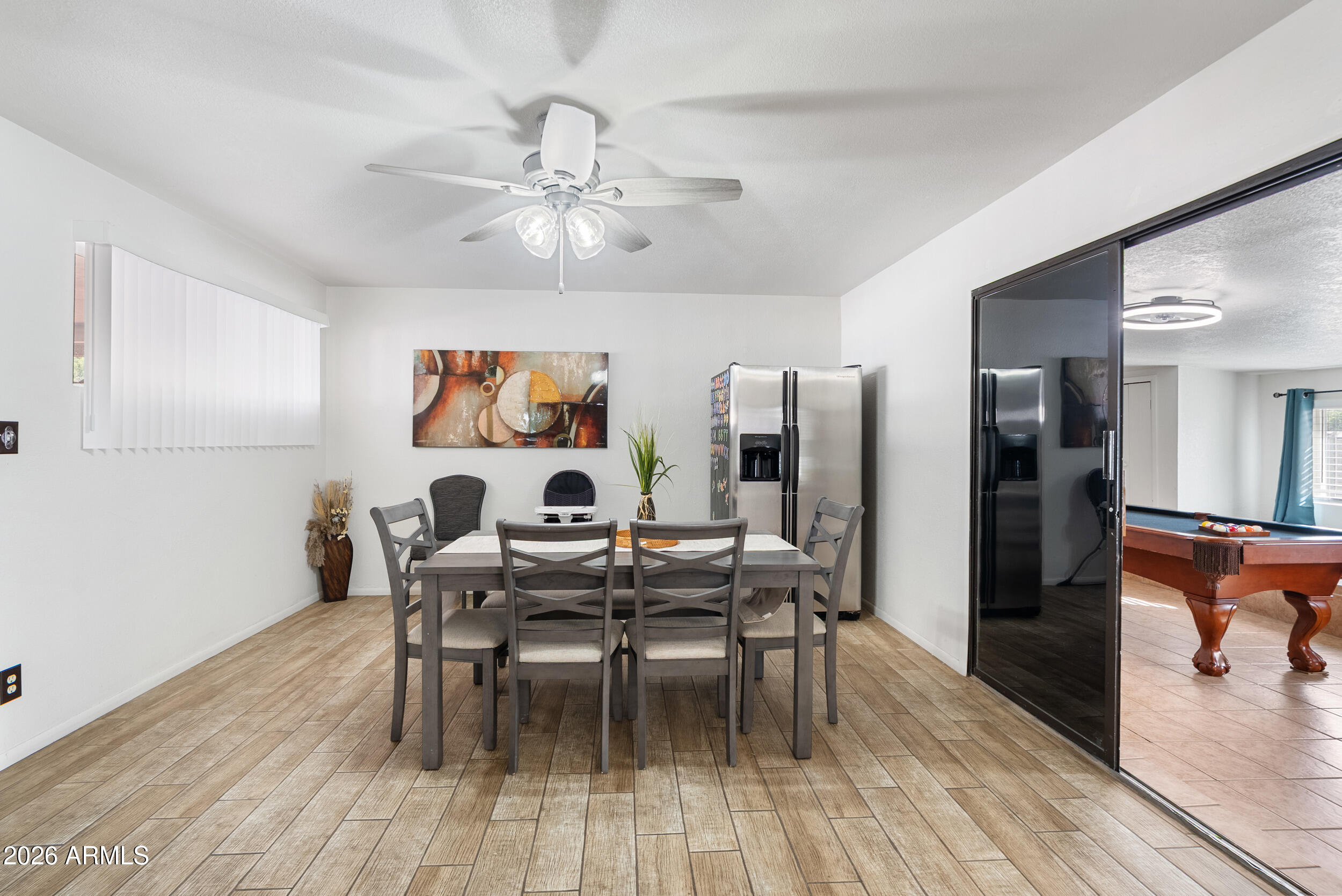 3631 West Colter Street Phoenix, AZ 85019 - Photo 15 of 45 a view of a dining room with furniture and wooden floor