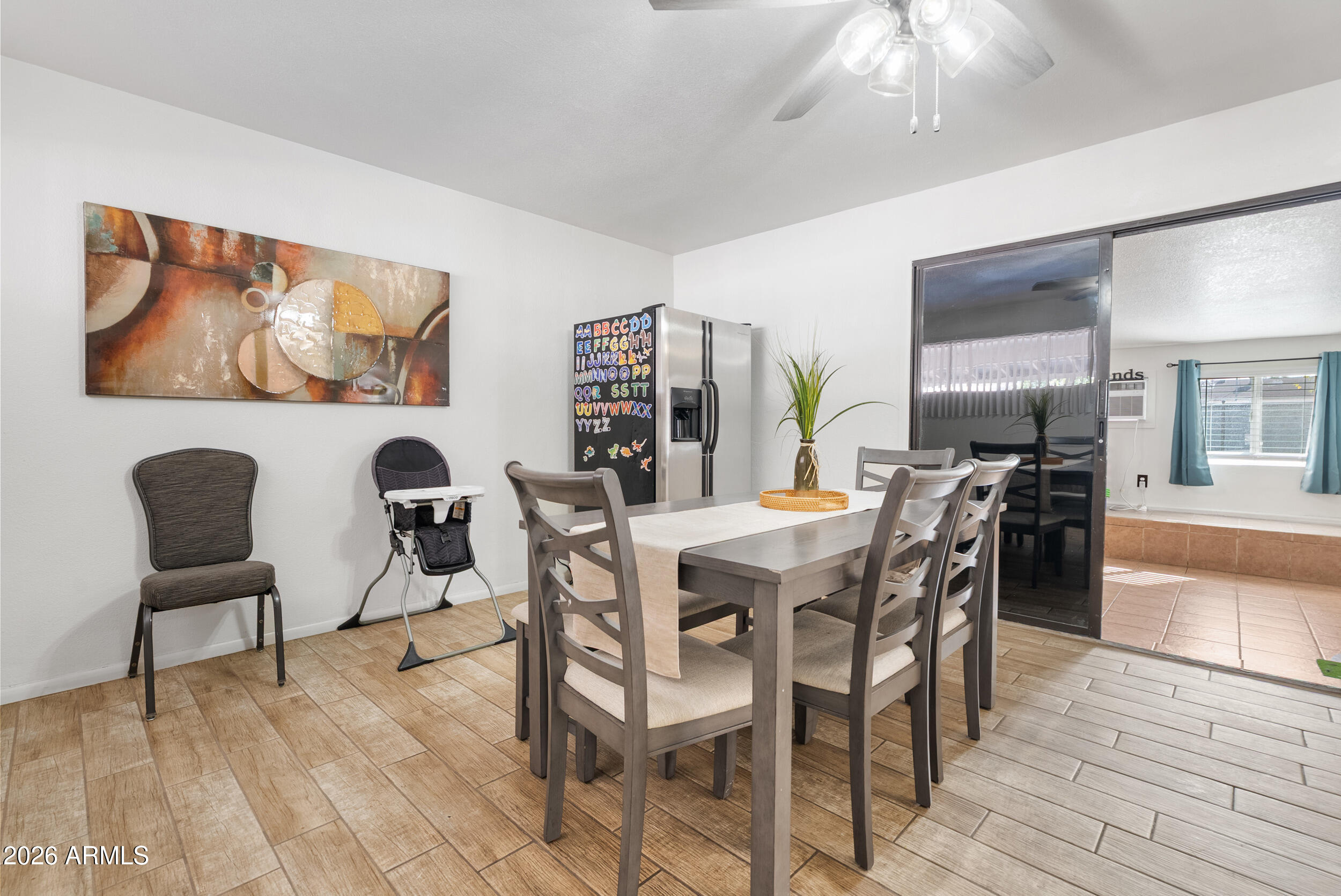3631 West Colter Street Phoenix, AZ 85019 - Photo 16 of 45 a view of a dining room with furniture and wooden floor