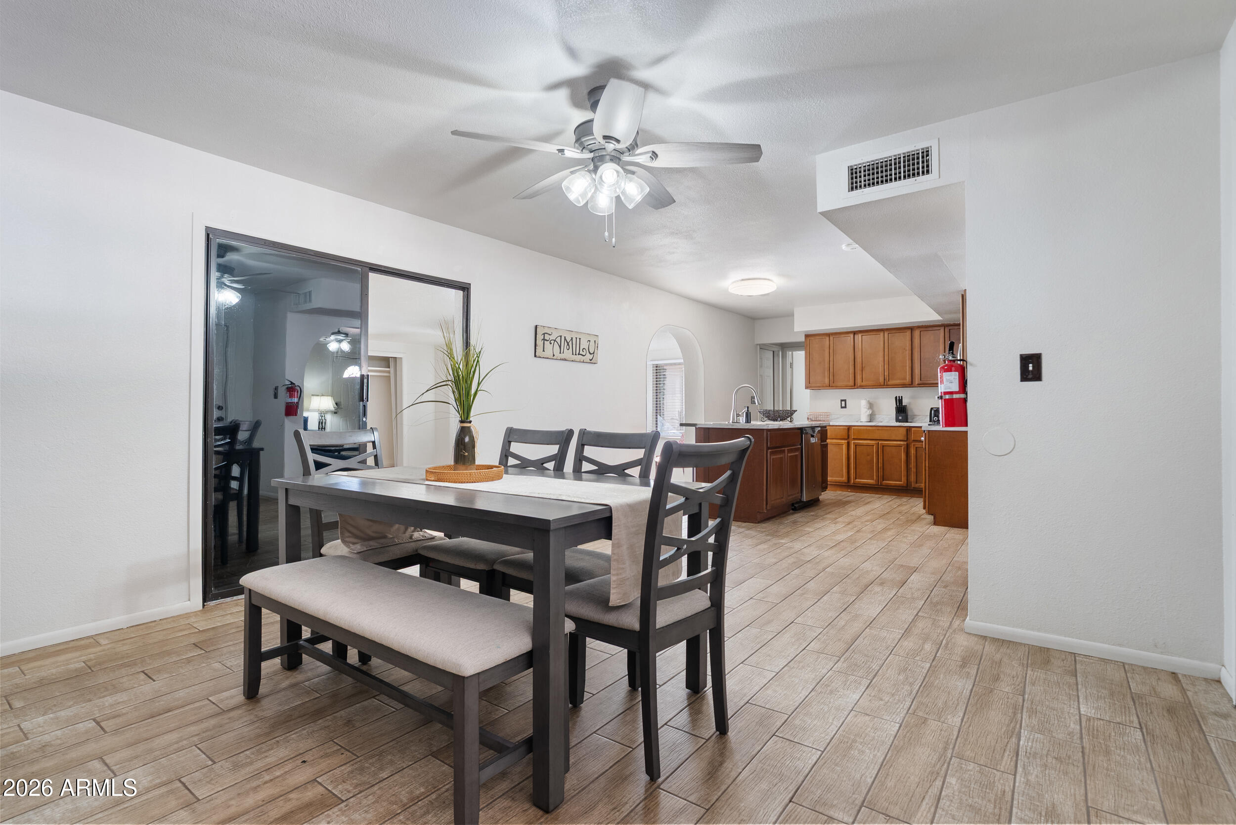 3631 West Colter Street Phoenix, AZ 85019 - Photo 17 of 45 a view of a dining room with furniture and wooden floor