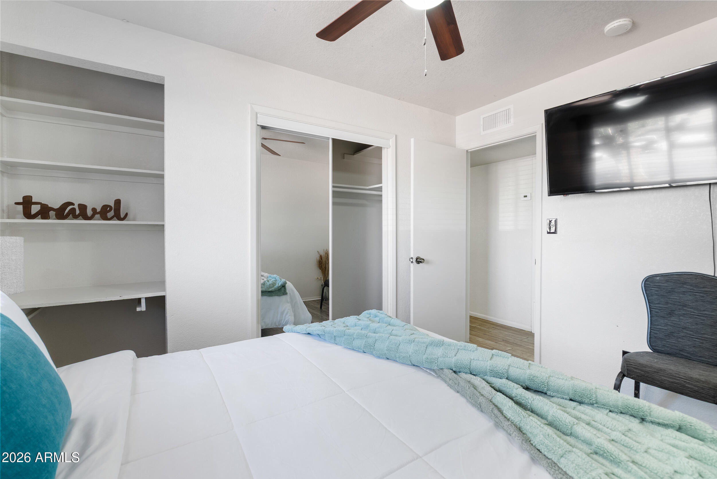 3631 West Colter Street Phoenix, AZ 85019 - Photo 24 of 45 a bedroom with a bed and a television