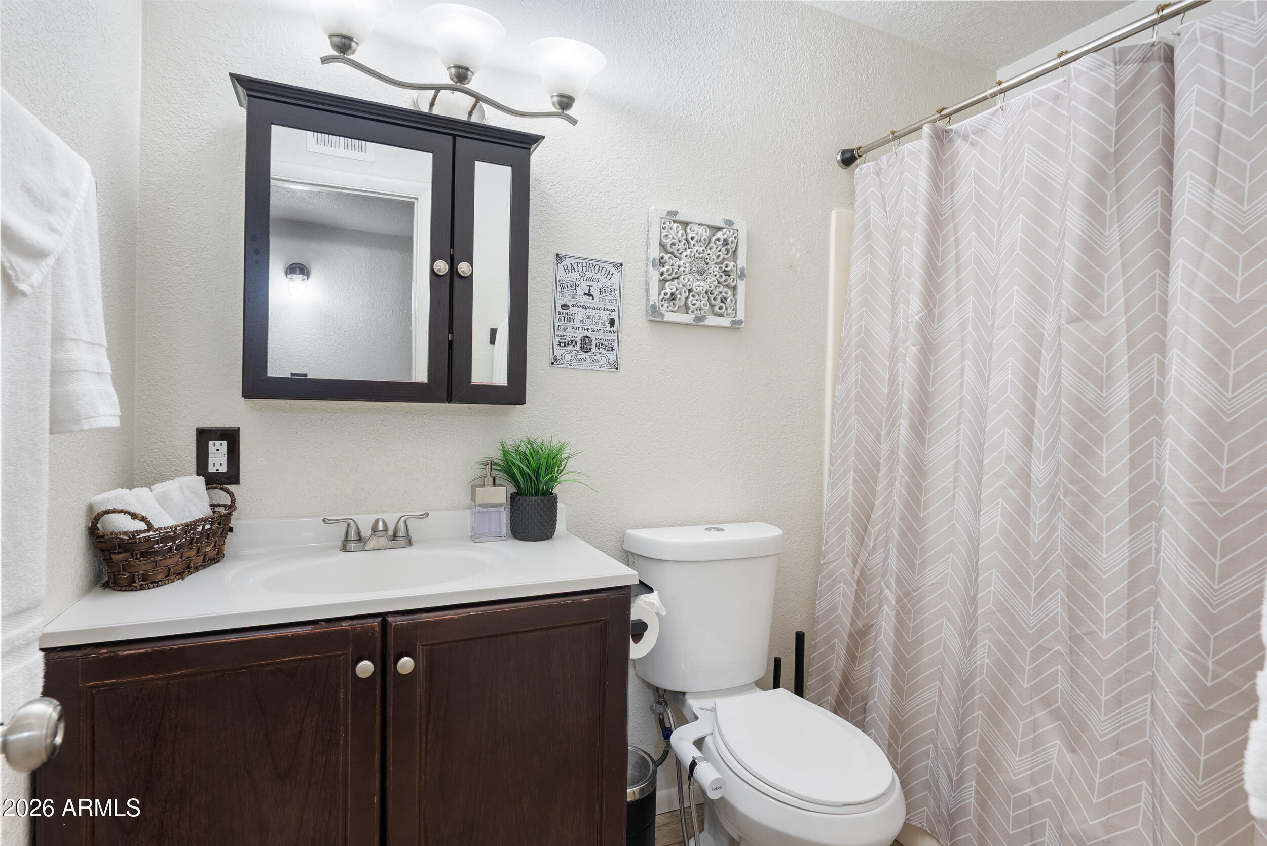 3631 West Colter Street Phoenix, AZ 85019 - Photo 25 of 45 a bathroom with a toilet a sink and a mirror