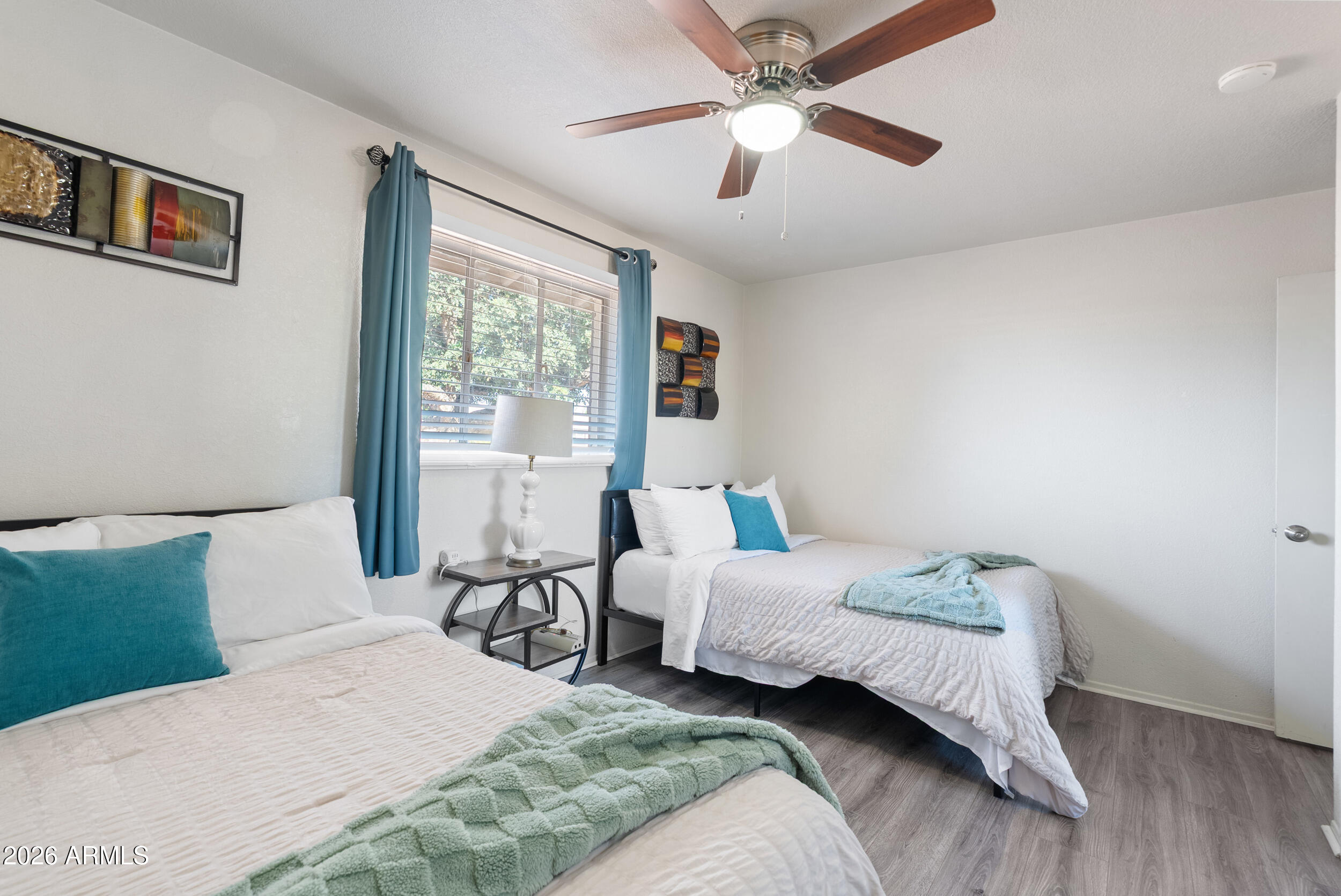 3631 West Colter Street Phoenix, AZ 85019 - Photo 27 of 45 a bedroom with a large bed and a window
