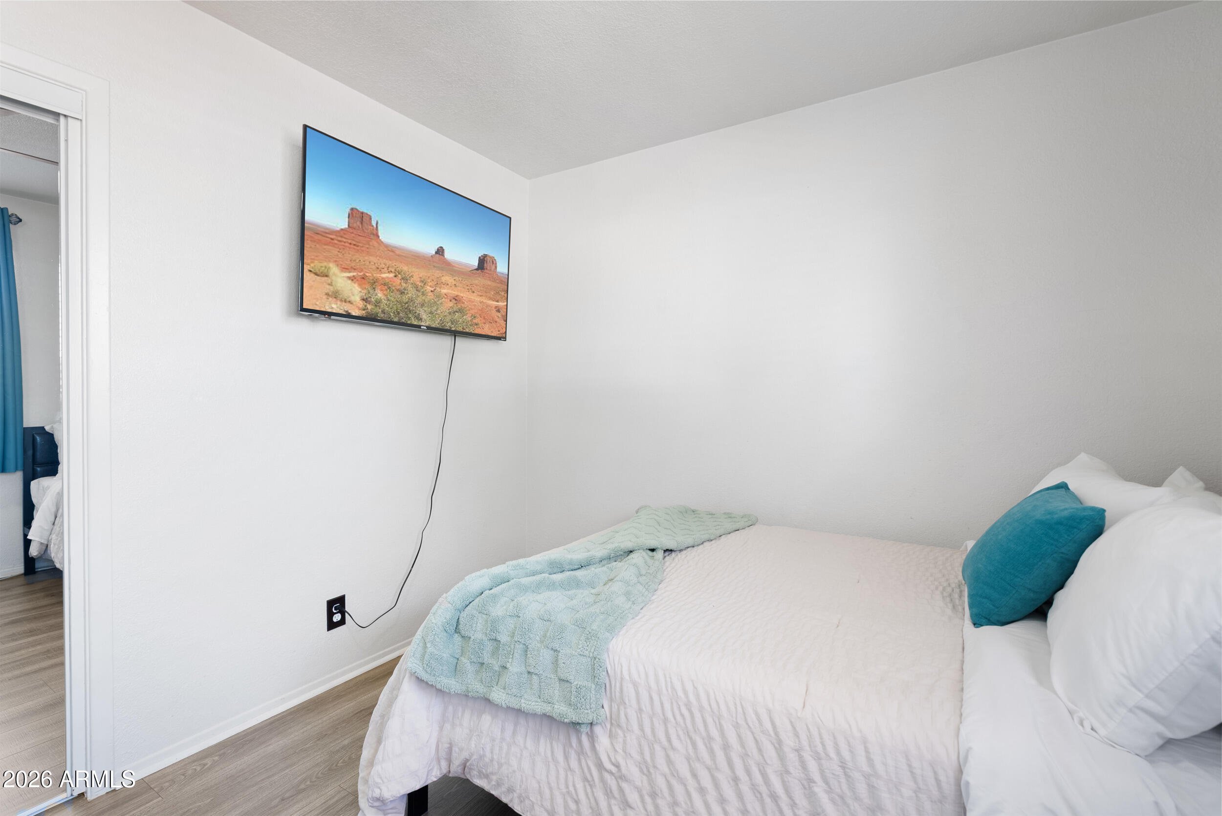 3631 West Colter Street Phoenix, AZ 85019 - Photo 28 of 45 a bedroom with a bed and a painting on the wall