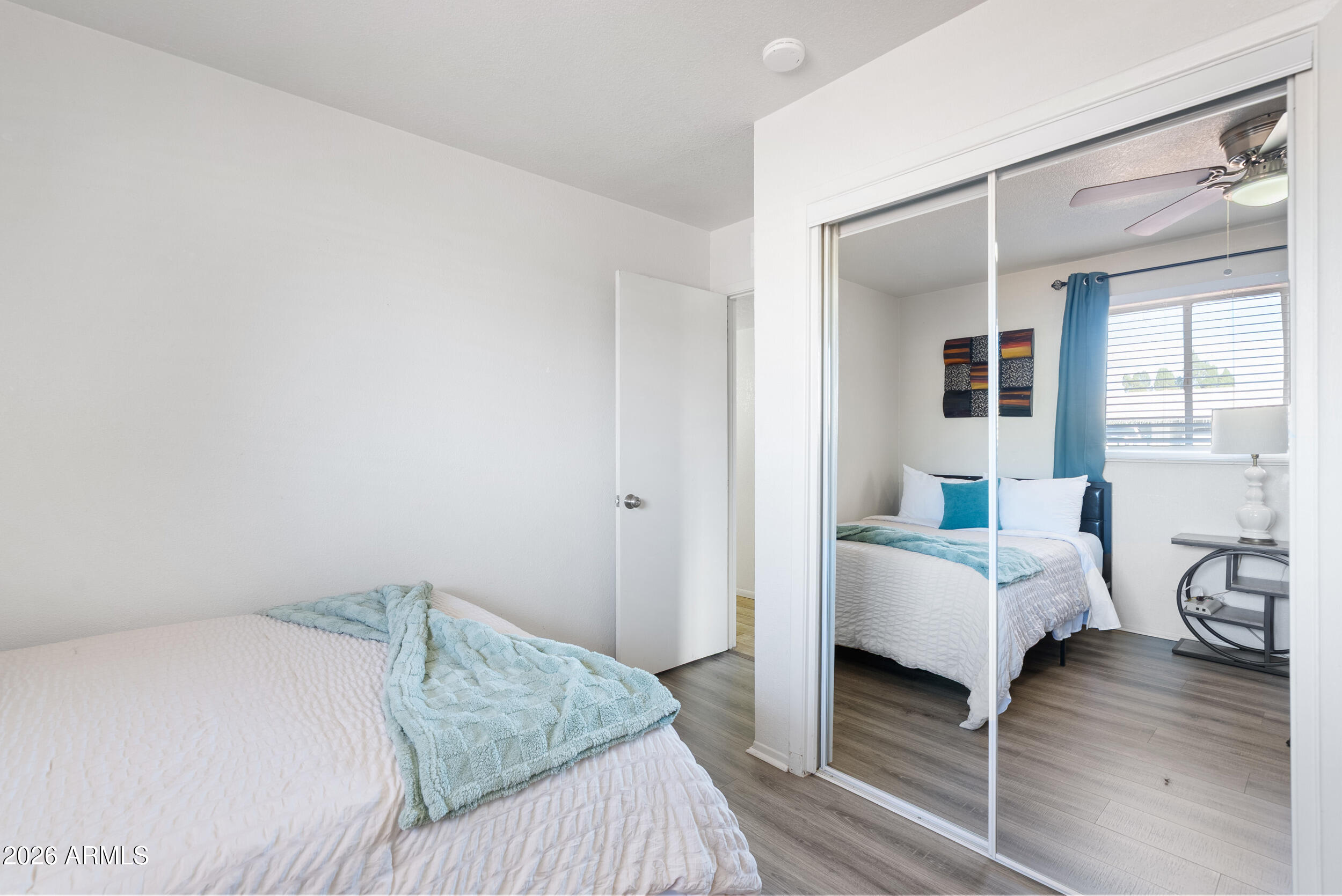 3631 West Colter Street Phoenix, AZ 85019 - Photo 29 of 45 a bedroom with a bed and wooden floor