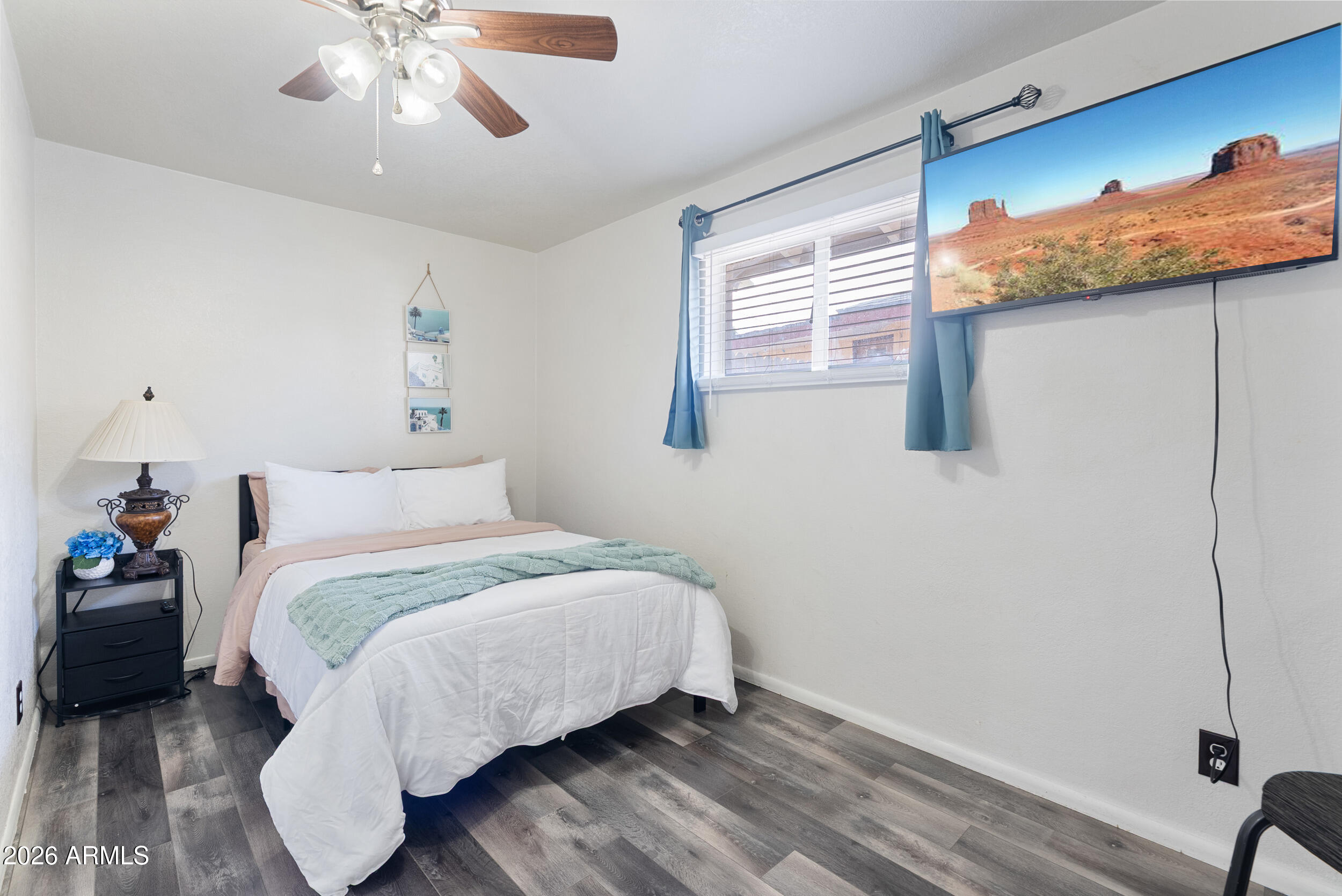 3631 West Colter Street Phoenix, AZ 85019 - Photo 30 of 45 a bedroom with a bed and wooden floor