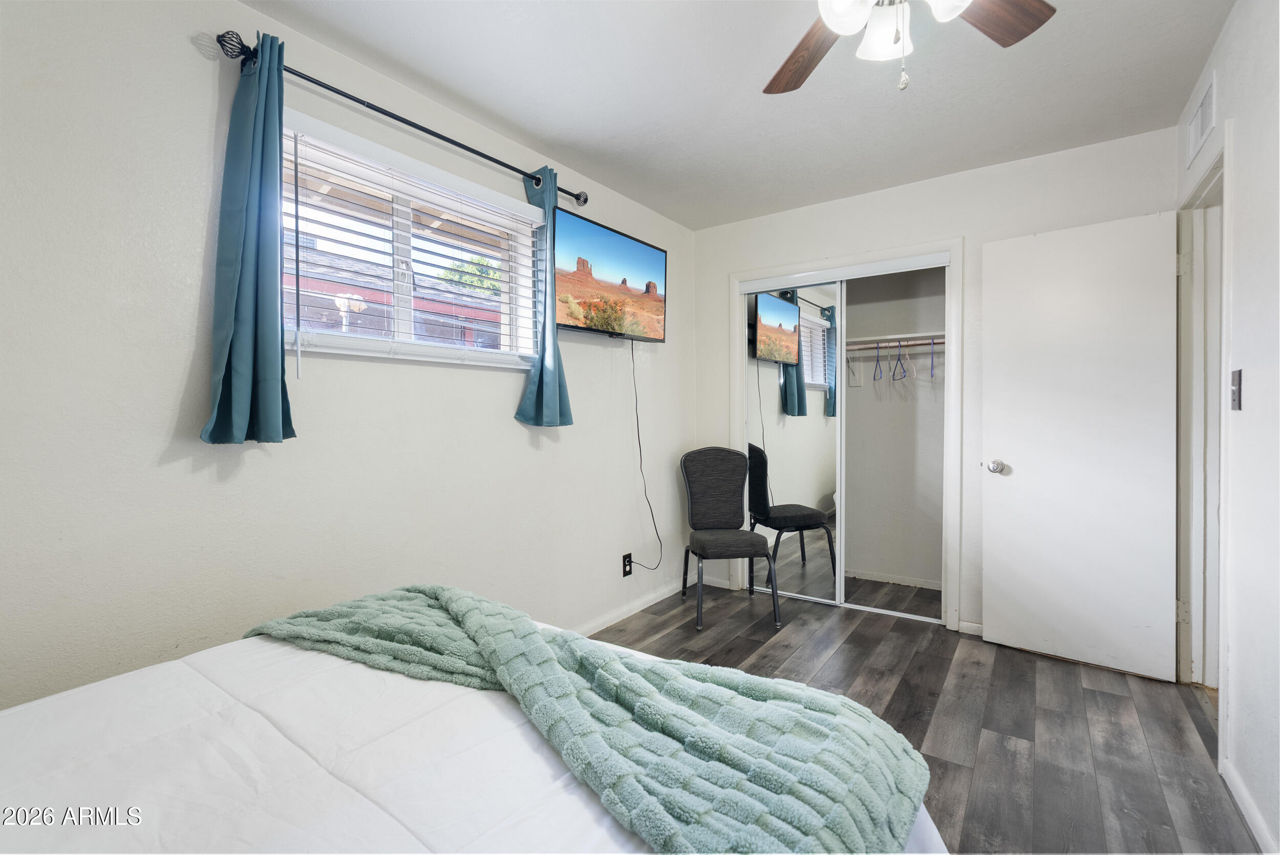 3631 West Colter Street Phoenix, AZ 85019 - Photo 31 of 45 a bedroom with a bed and a chair