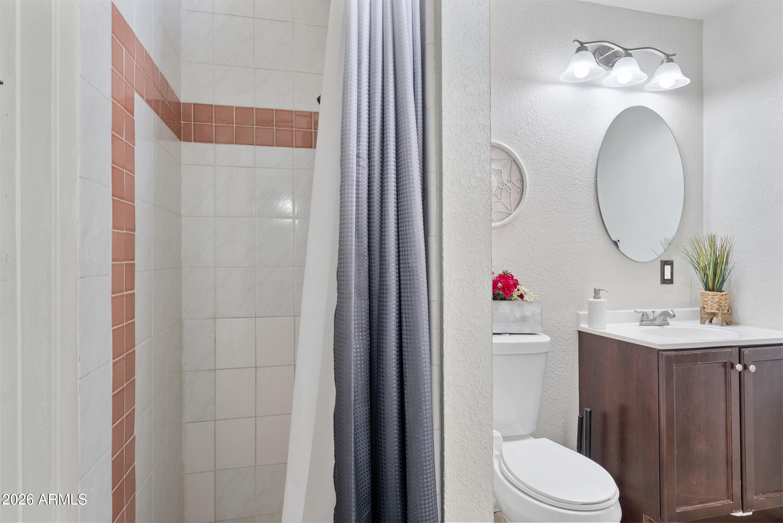 3631 West Colter Street Phoenix, AZ 85019 - Photo 32 of 45 a bathroom with a sink vanity mirror and toilet
