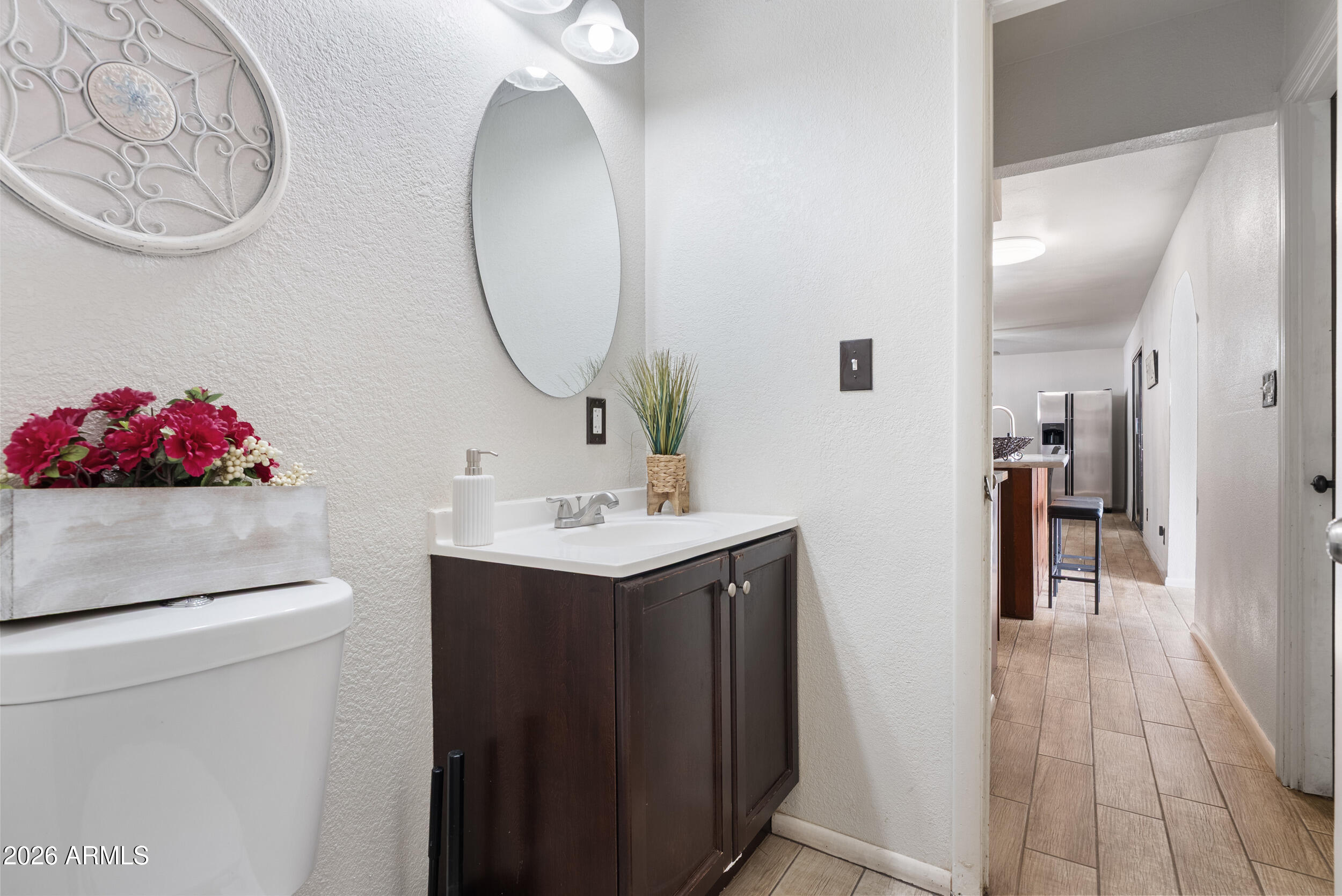3631 West Colter Street Phoenix, AZ 85019 - Photo 33 of 45 a bathroom with a sink vanity and a mirror