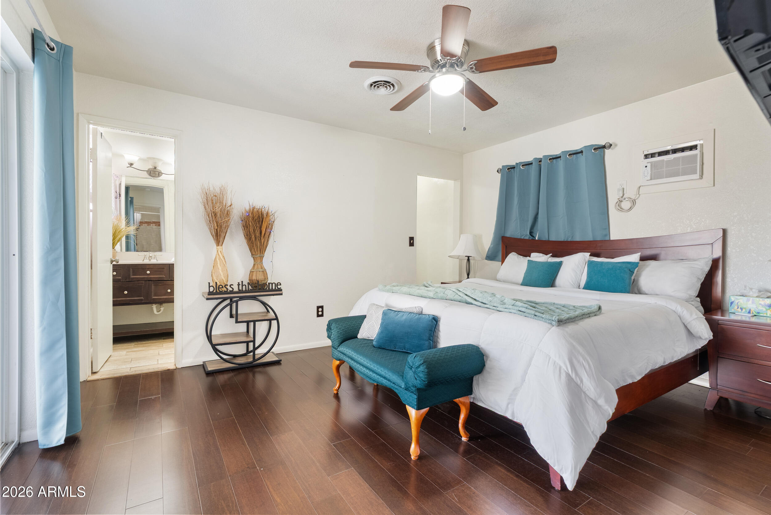 3631 West Colter Street Phoenix, AZ 85019 - Photo 34 of 45 a bedroom with a bed and a chandelier