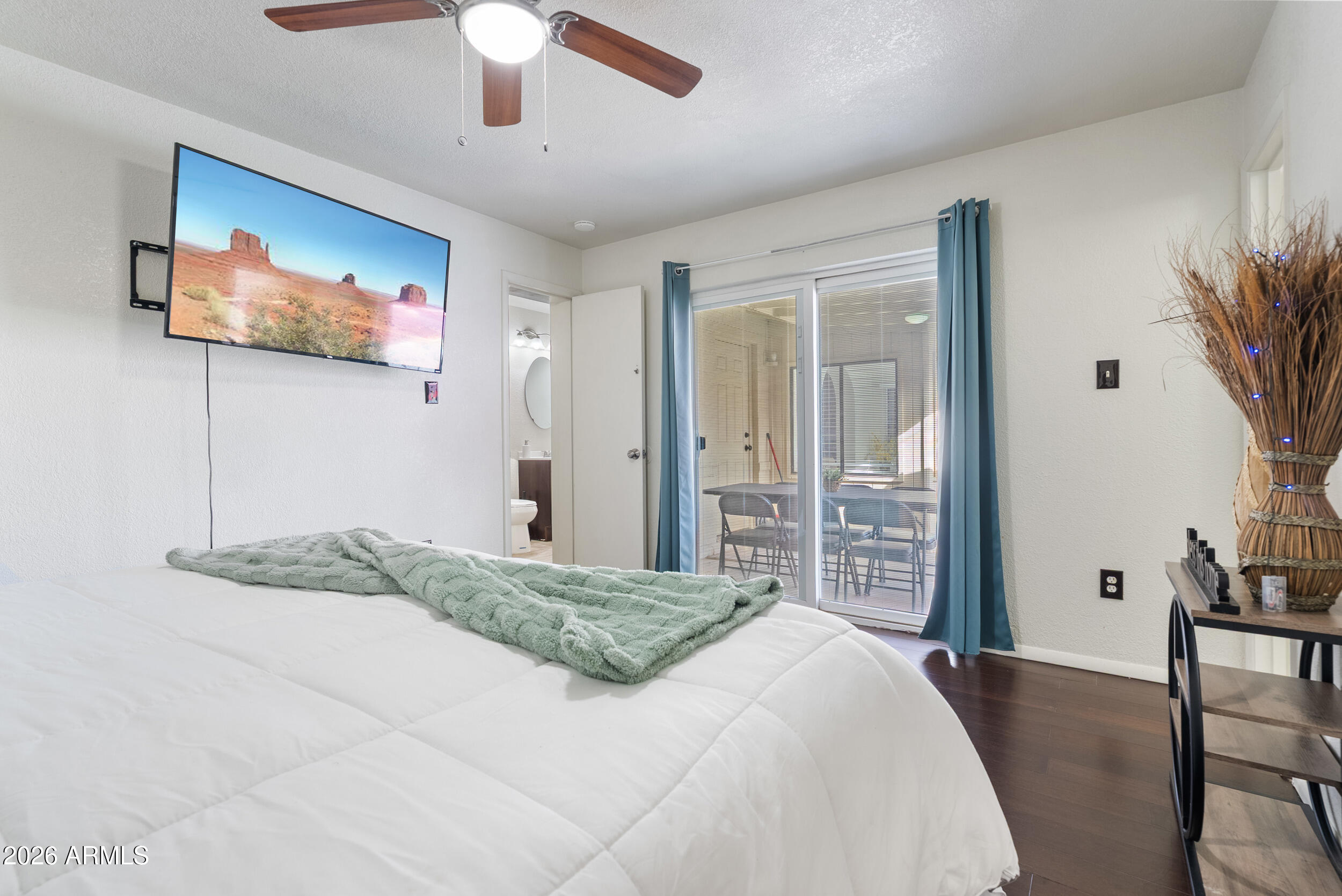 3631 West Colter Street Phoenix, AZ 85019 - Photo 35 of 45 a bedroom with a large bed and a flat screen tv