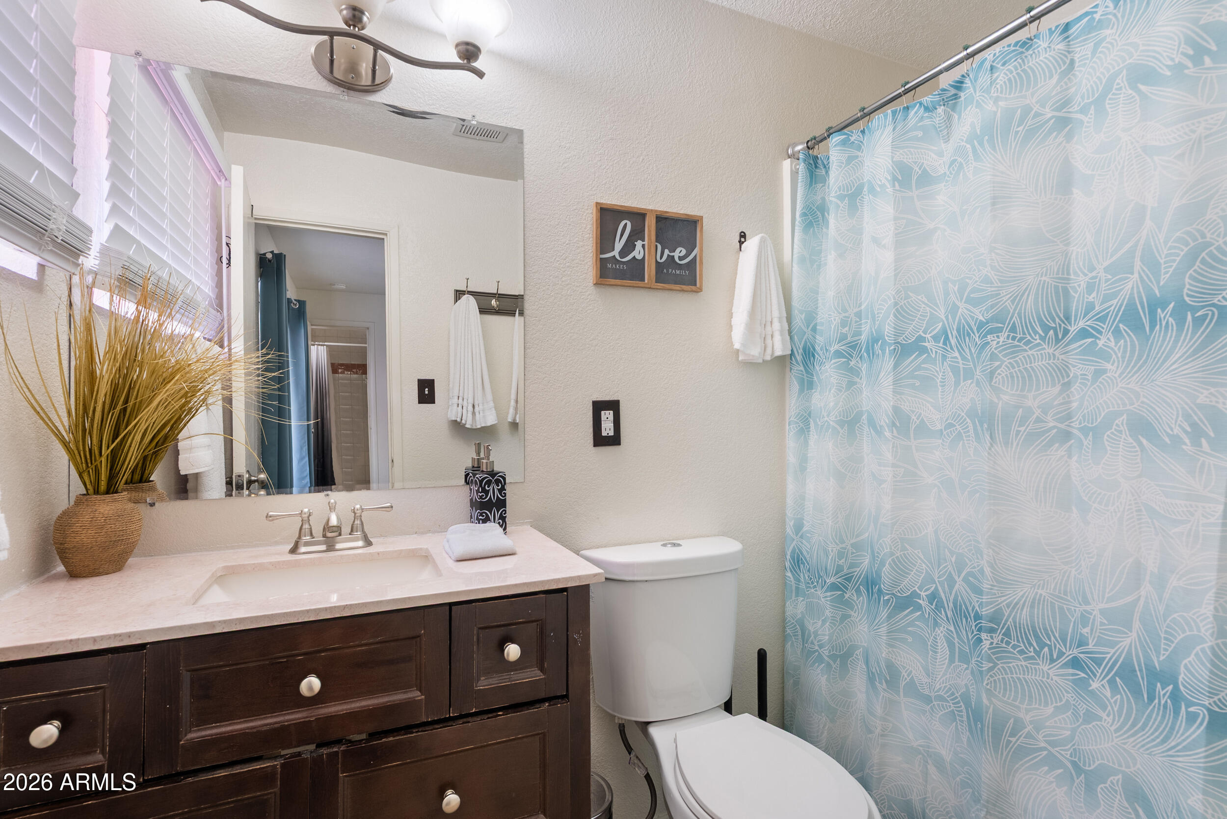 3631 West Colter Street Phoenix, AZ 85019 - Photo 36 of 45 a bathroom with a sink a toilet and shower
