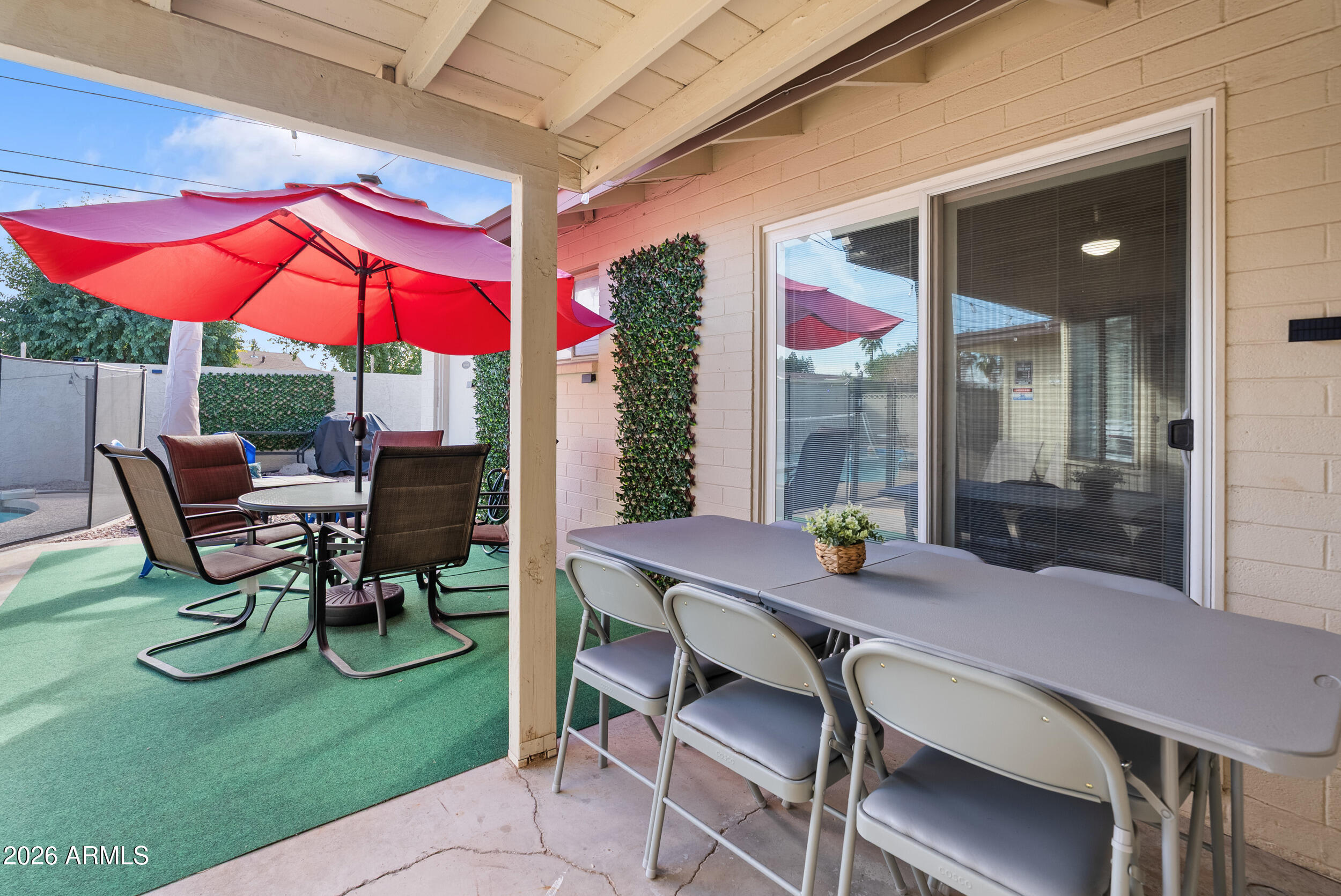 3631 West Colter Street Phoenix, AZ 85019 - Photo 37 of 45 a table and chairs in the patio