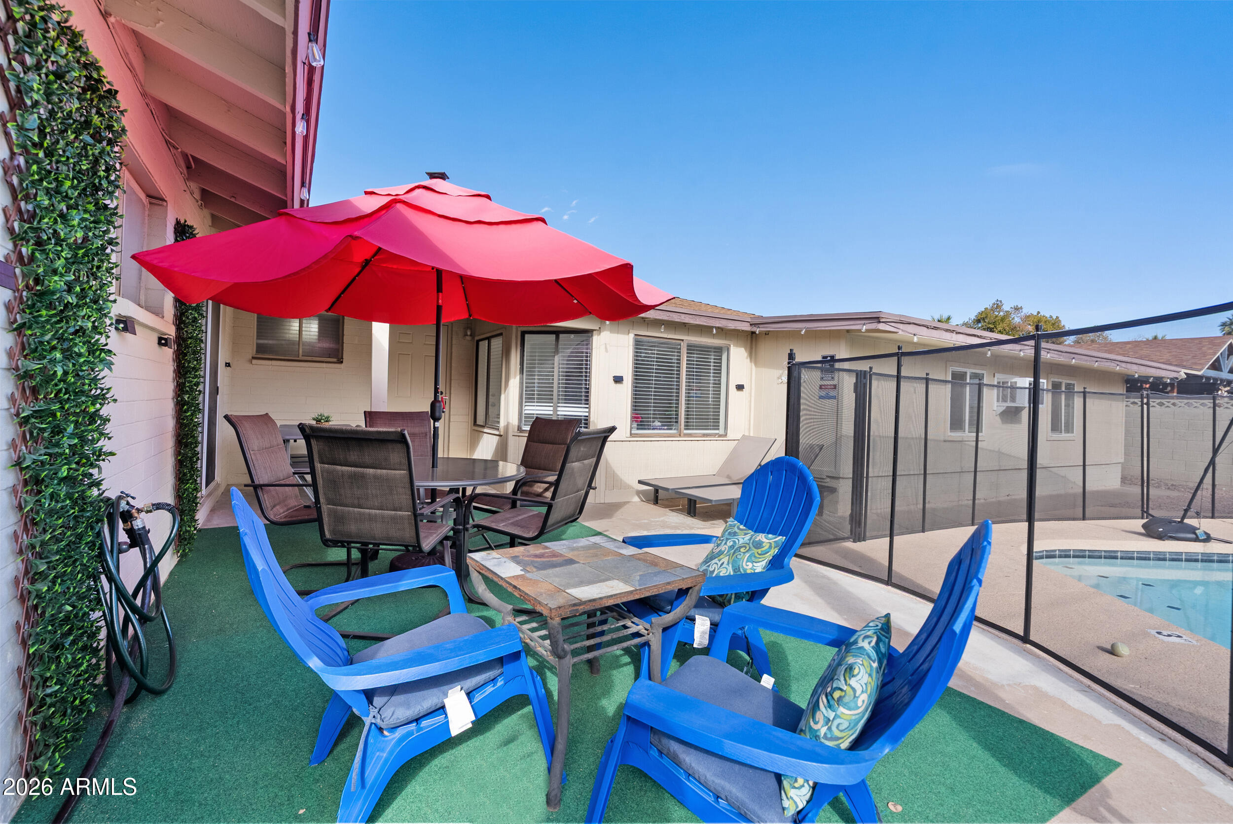 3631 West Colter Street Phoenix, AZ 85019 - Photo 39 of 45 a view of a patio with a table and chairs under an umbrella