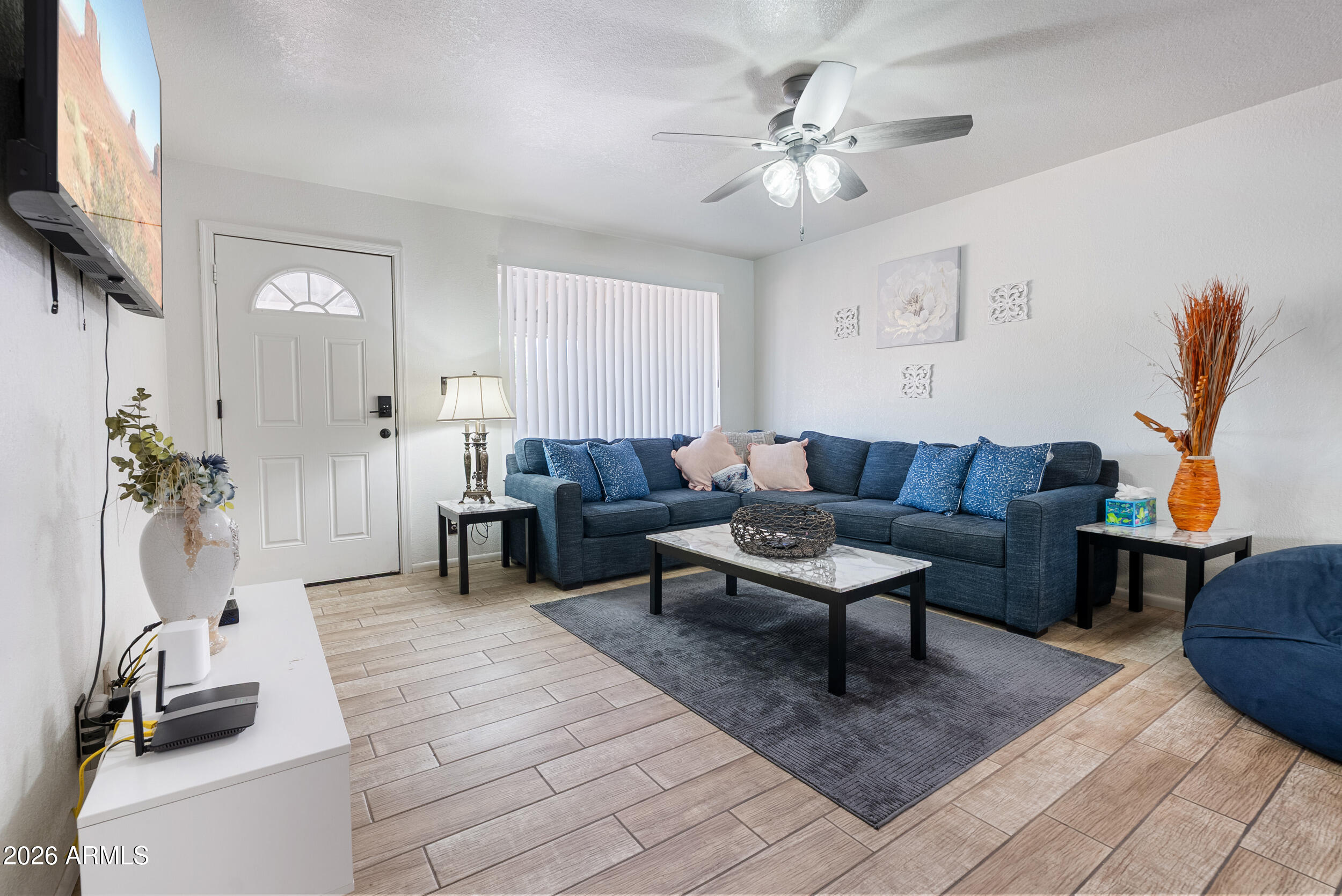 3631 West Colter Street Phoenix, AZ 85019 - Photo 5 of 45 a living room with furniture a rug and a flat screen tv