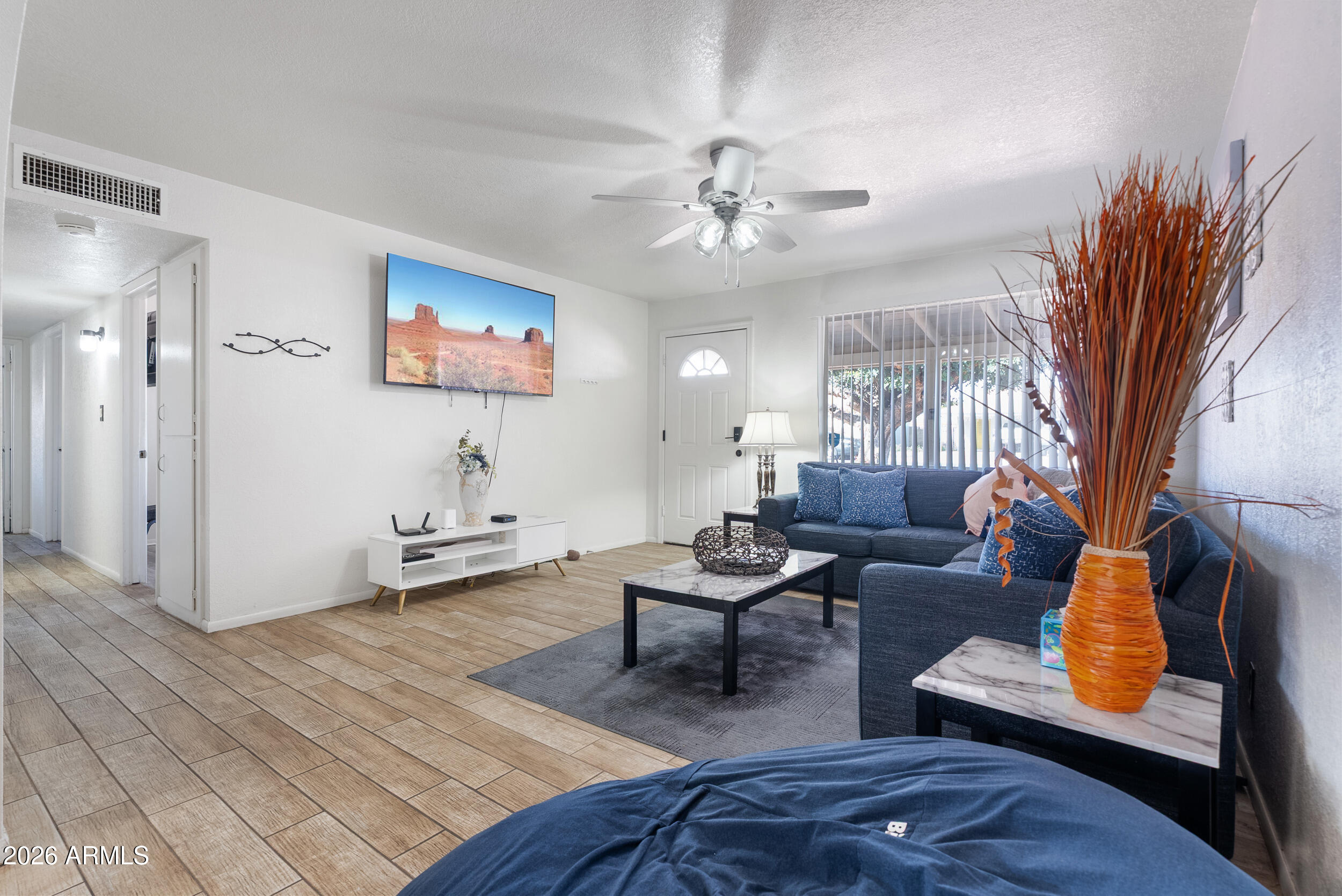 3631 West Colter Street Phoenix, AZ 85019 - Photo 6 of 45 a living room with furniture and a flat screen tv