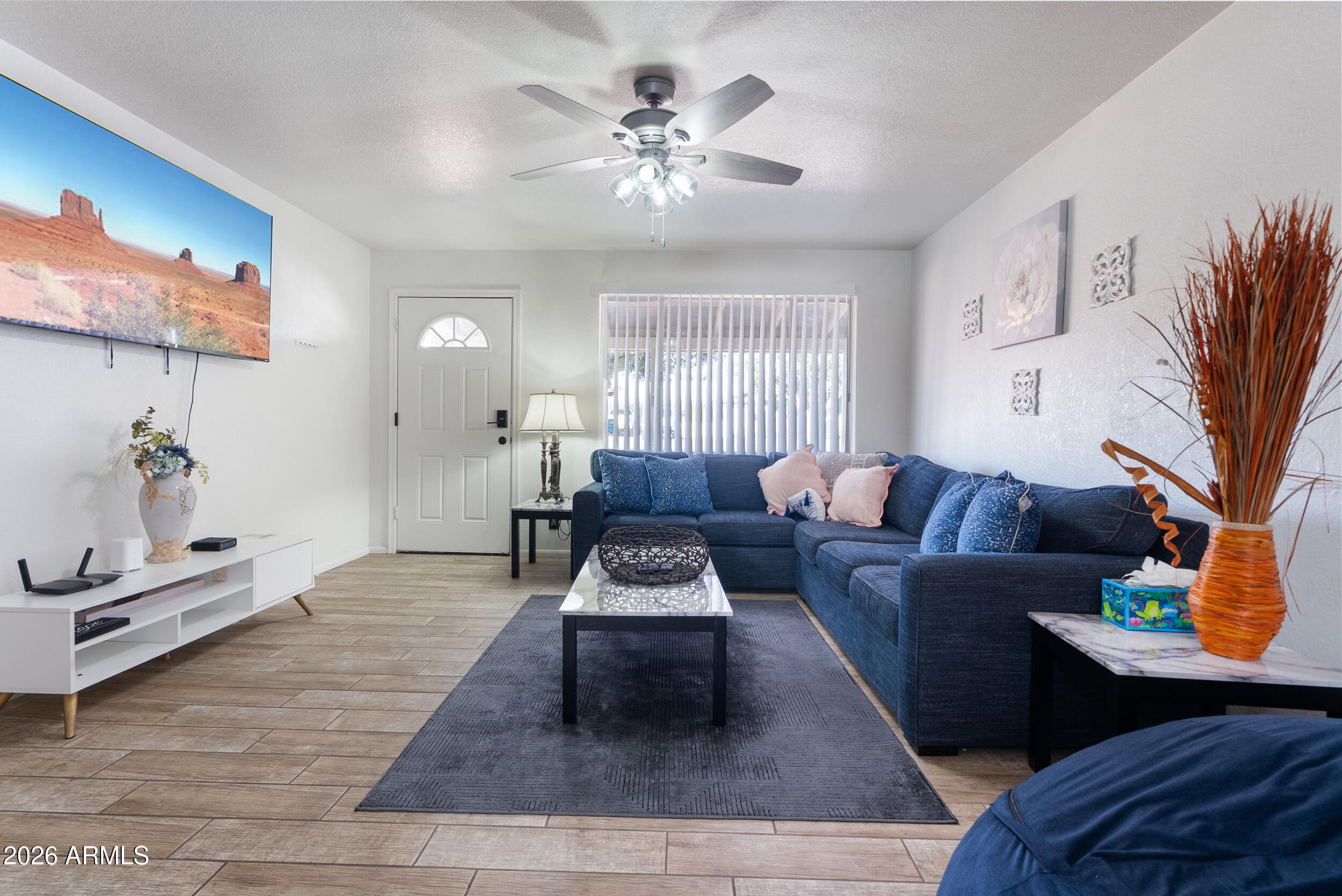 3631 West Colter Street Phoenix, AZ 85019 - Photo 7 of 45 a living room with furniture and a chandelier