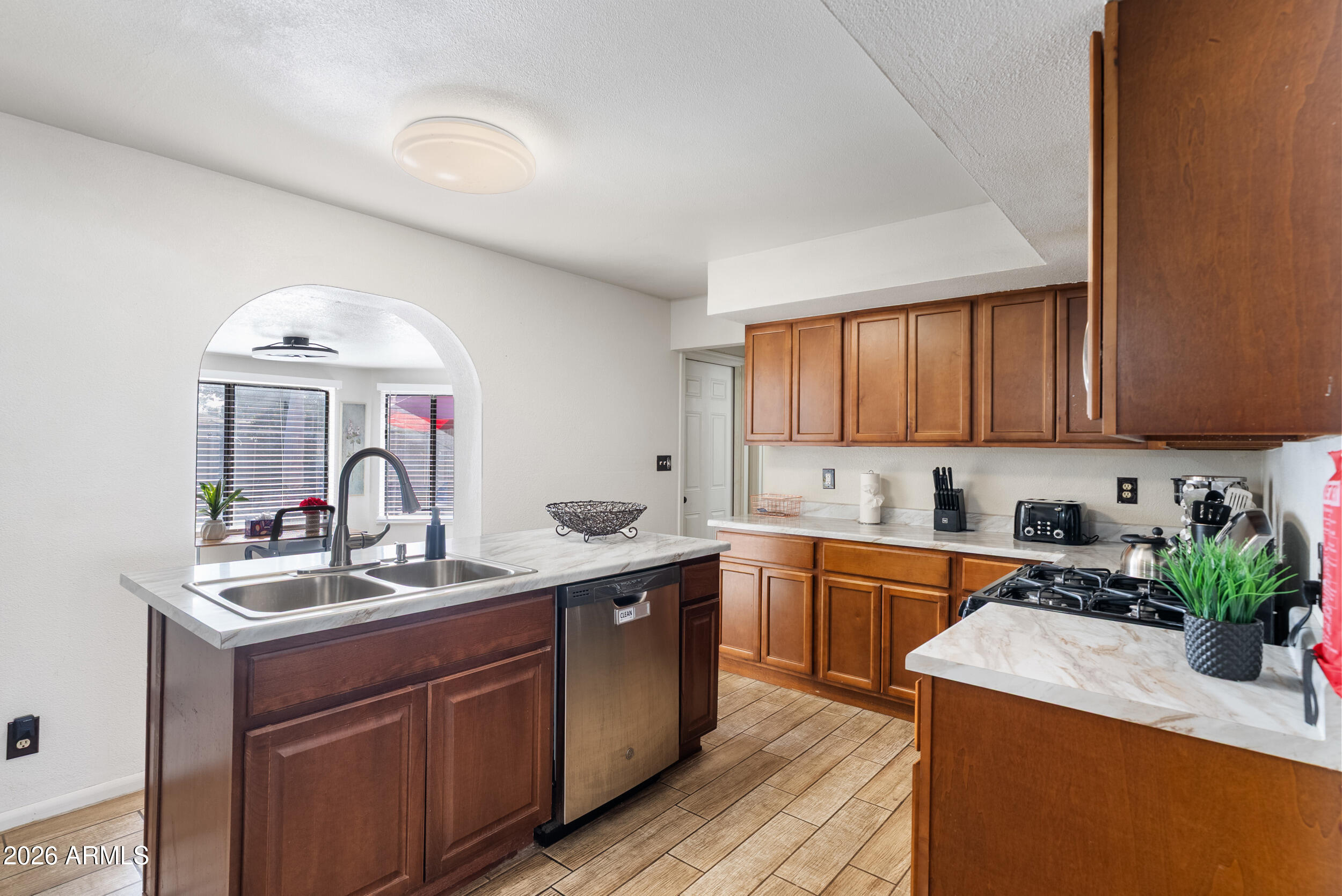 3631 West Colter Street Phoenix, AZ 85019 - Photo 8 of 45 a kitchen with a sink stove and cabinets