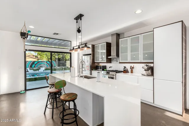a kitchen with sink cabinets and wooden floor