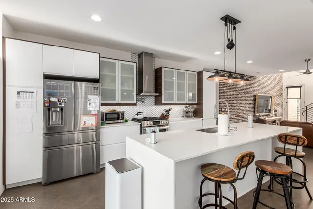 a kitchen with refrigerator and cabinets