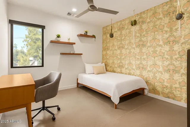 a bedroom with a bed and a chair