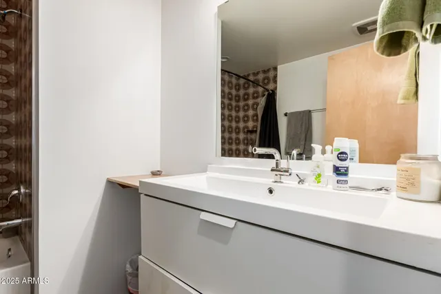 a bathroom with a sink and a mirror