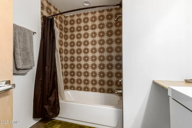 a bathroom with a bathtub and a shower