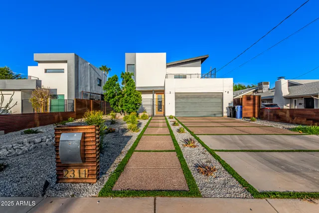 a view of multiple houses with a street