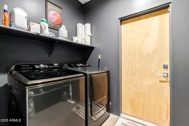 a bedroom with bed and a chandelier