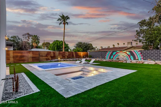 a view of swimming pool with a lounge chairs
