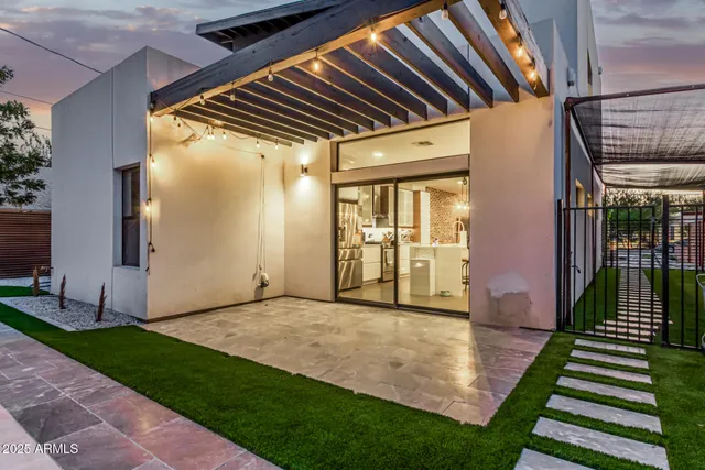 a view of an house with backyard space and balcony