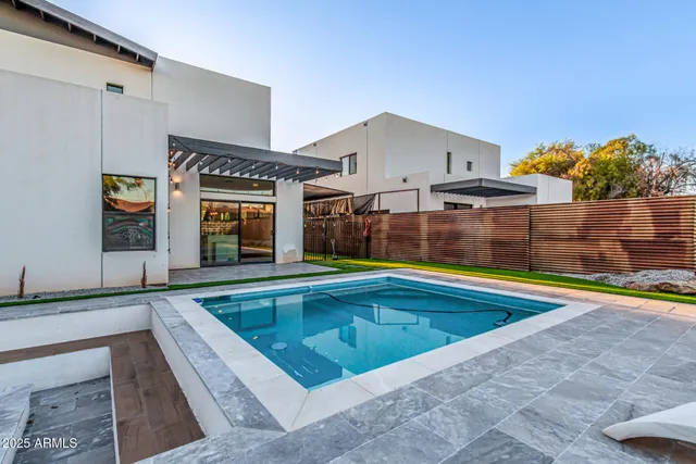 a view of swimming pool with seating area and barbeque oven