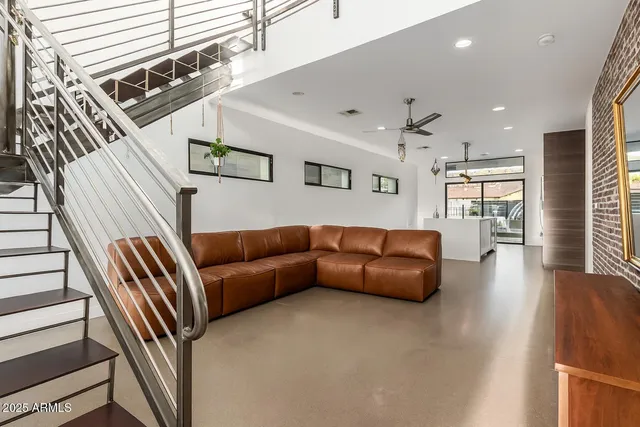 a living room with furniture and a ceiling fan