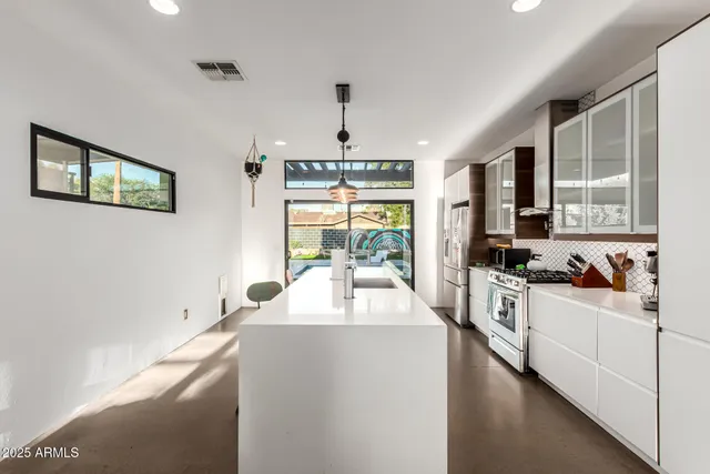 a kitchen with sink refrigerator and window
