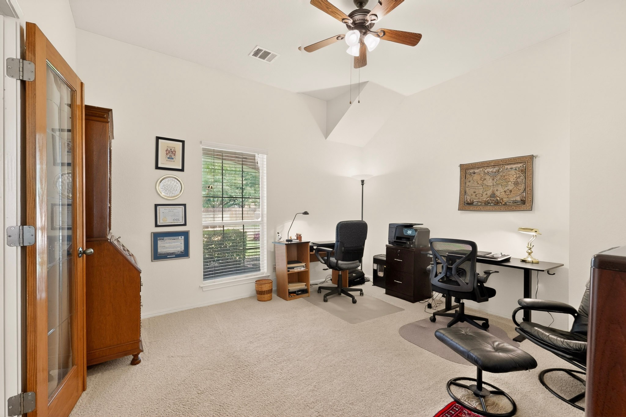 905 Victoria Ridge Drive Pflugerville, TX 78660 - Photo 10 of 32 A well-lit home office features a vaulted ceiling and ample workspace for productivity.