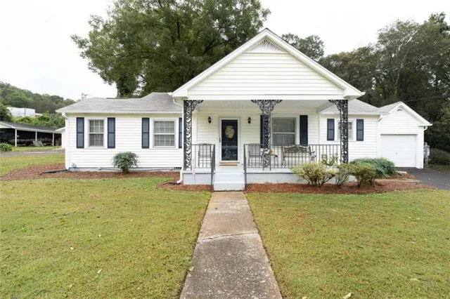 a front view of a house with garden