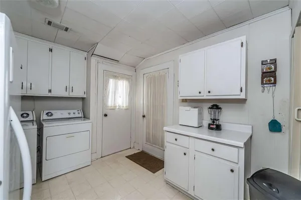 a kitchen with cabinets appliances and a sink