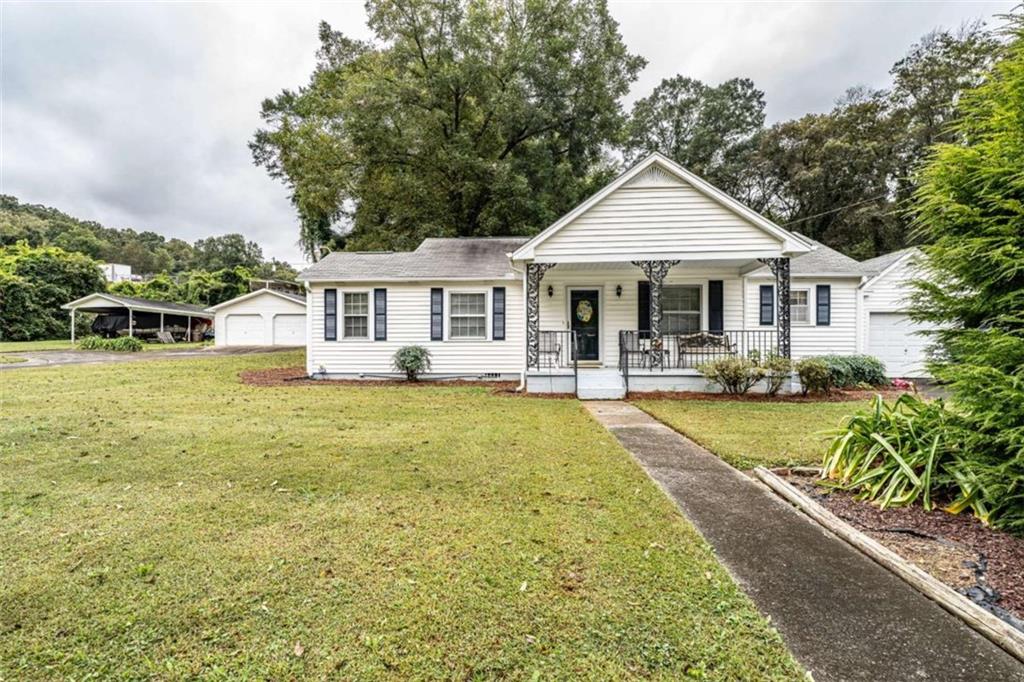 13 Spring Circle Southeast Lindale, GA 30147 - Photo 2 of 25 a front view of a house with swimming pool and porch
