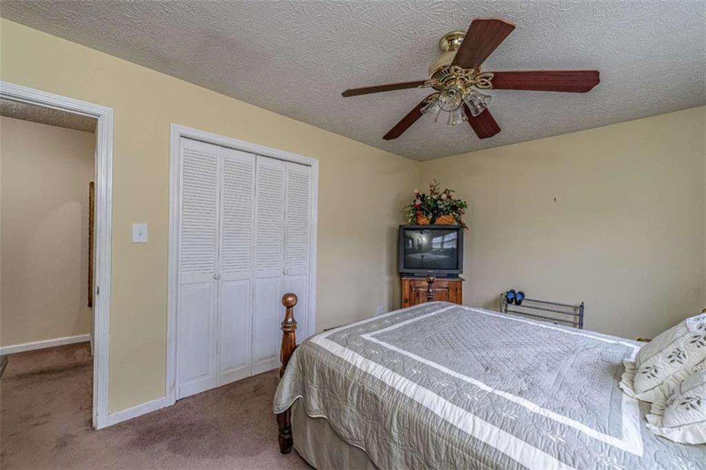 13 Spring Circle Southeast Lindale, GA 30147 - Photo 21 of 25 a bedroom with a bed and a chandelier