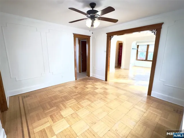 a view of a hallway with a chandelier fan and a porch