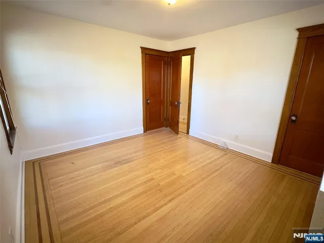an empty room with wooden floor