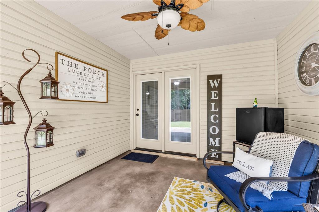 814 Springdale Circle Lorena, TX 76655 - Photo 25 of 37 Covered patio featuring a ceiling fan with leaf-shaped blades, light-colored siding, and concrete flooring