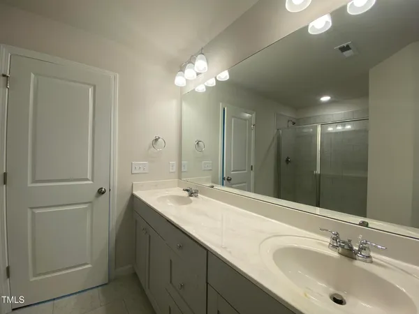 a bathroom with a sink double vanity and a mirror