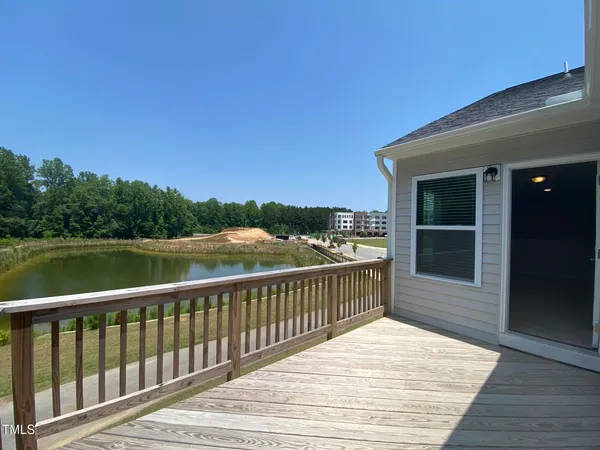 a view of a balcony with wooden floor and lake view