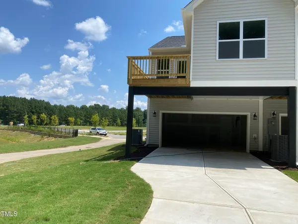 a view of a house with a yard and garage
